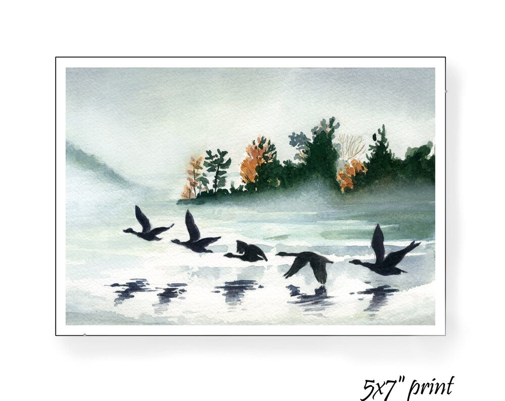 Geese taking flight over a foggy lake in Fall